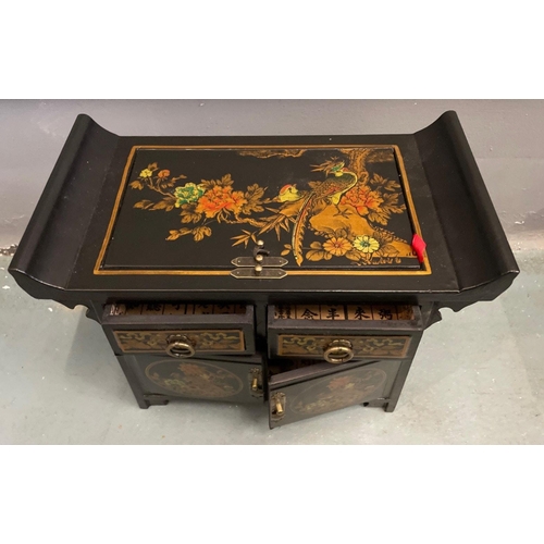 322 - An ORIENTAL HIGHLY decorative black and gold painted and floral lacquered black based 2 drawer stool... 