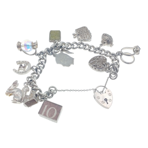 33 - A LOVELY SILVER stamped charm chain with 11 unusual charms - gross weight 6.60g approx#50