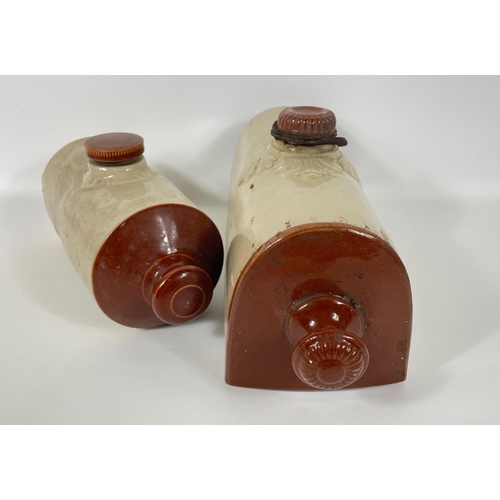 375 - Two stoneware pigs, the smaller has a hairline crack, the larger has a flat base and measures 32x18c... 