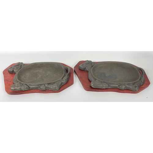 376 - A pair of cast iron and wooden sizzler steak platters 33cm long#440