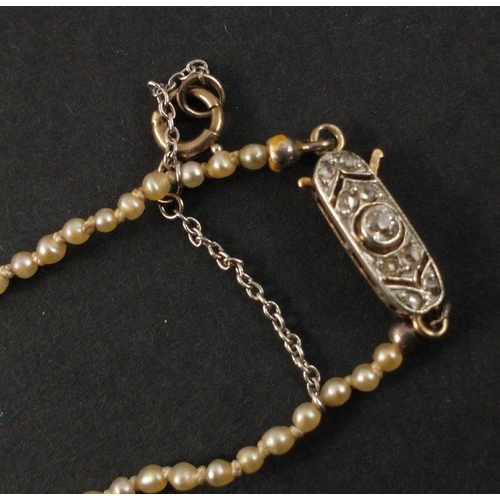 50A - A pretty VINTAGE c1930's graduating seed pearl and diamond centred (tested) clasp necklace, the clas... 