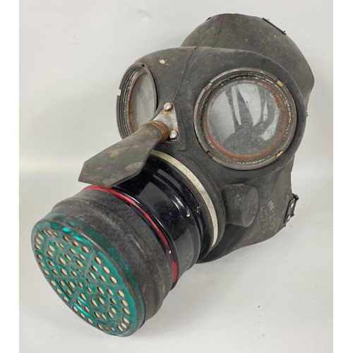 107A - Two GAS MASKS, the first, in a fragile state, is a rare civilian single eyepiece respirator stamped ... 