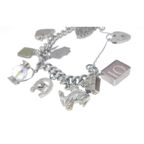 12 - A LOVELY SILVER stamped charm chain with 11 unusual charms - gross weight 6.60g approx#26