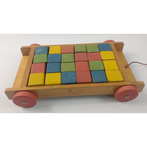 224 - A VINTAGE c1960's TRI-ANG Baby Walker 40cm x 25cm approx with a pull-along building bricks small car... 