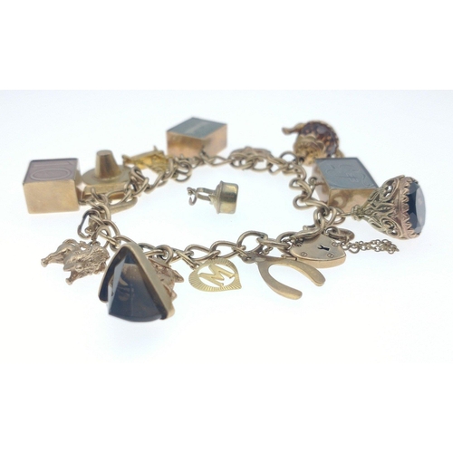 2N - A 375 stamped gold charm bracelet weight 40.10g gross to include a white gold small kettle 9ct stamp... 