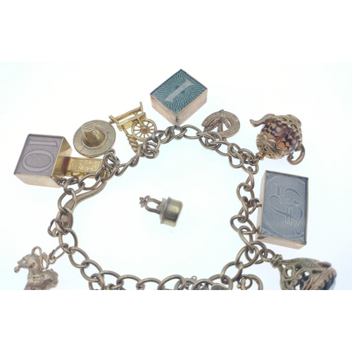 2N - A 375 stamped gold charm bracelet weight 40.10g gross to include a white gold small kettle 9ct stamp... 