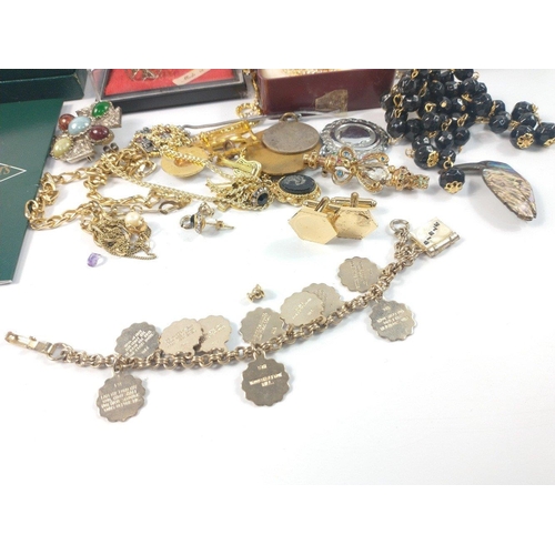 39 - A quantity of costume jewellery to include a vintage charm bracelet with the ten commandments and va... 