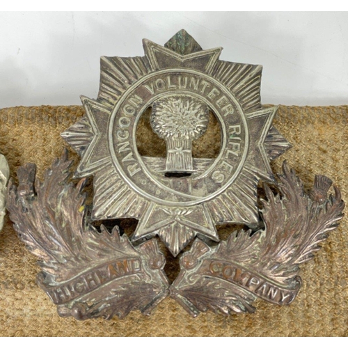 83 - Of military interest - a belt with fourteen badges and buttons including a BRITISH LIGHT INFANTRY 