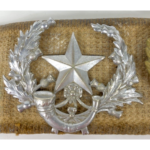 83 - Of military interest - a belt with fourteen badges and buttons including a BRITISH LIGHT INFANTRY 