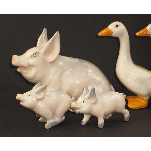 97 - A collection of mainly BESWICK farmyard animals to include a ewe and 2 lambs, a large pig (approx 12... 