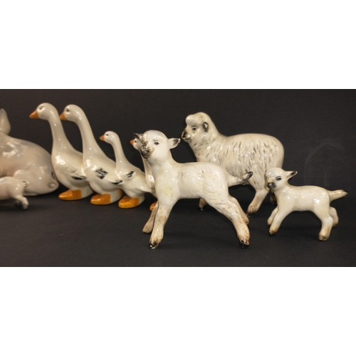 97 - A collection of mainly BESWICK farmyard animals to include a ewe and 2 lambs, a large pig (approx 12... 