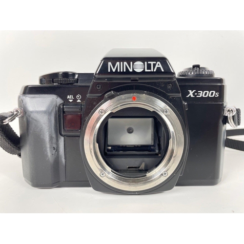 274 - MINOLTA x 300  CAMERA with Zoom Lens and a TAMRON Zoom Lens in a United Colors of BENETTON  Bag.#78... 