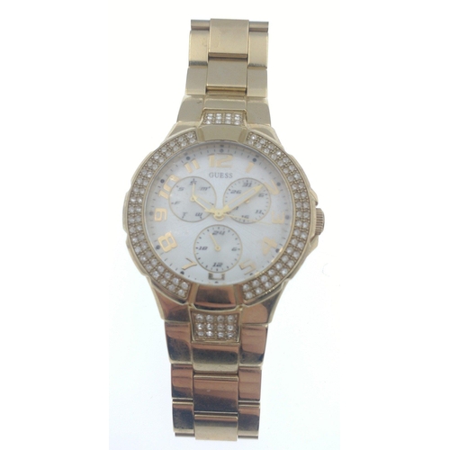 63 - A GUESS FASHION yellow metal watch within its original box with with multiple dials on the watch fac... 