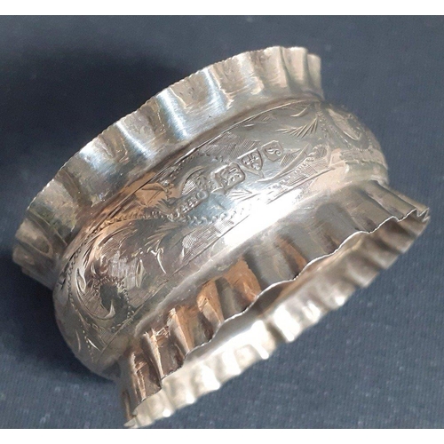 102 - A pair of solid silver napkin rings with crimped edges and attractive floral scrolling.  Dated 1909 ... 