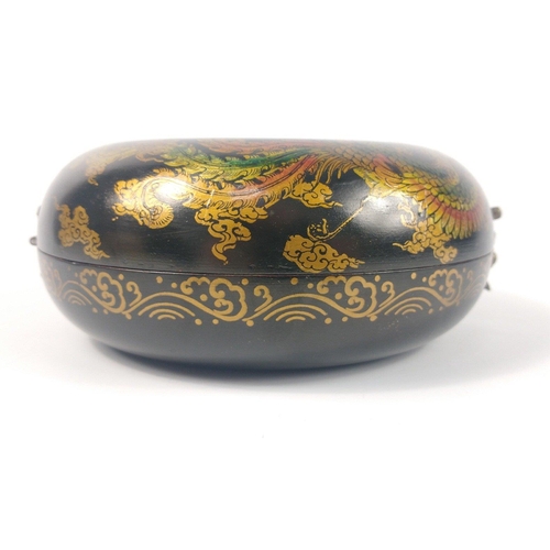 157 - A wooden lacquered Chinese doughnut-shaped jewellery box in black, with brass fastenings, decorated ... 