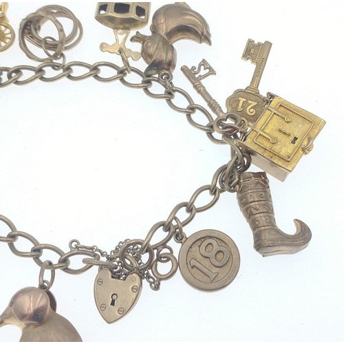 20 - A LOVELY 375 stamped yellow gold locket and charm bracelet FULL OF GOLD CHARMS, to include a safe, a... 