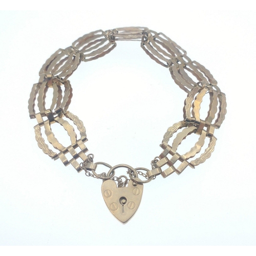 21 - A nice 375 stamped yellow gold bracelet with heart shaped locket and safety chain - weight 10g appro... 