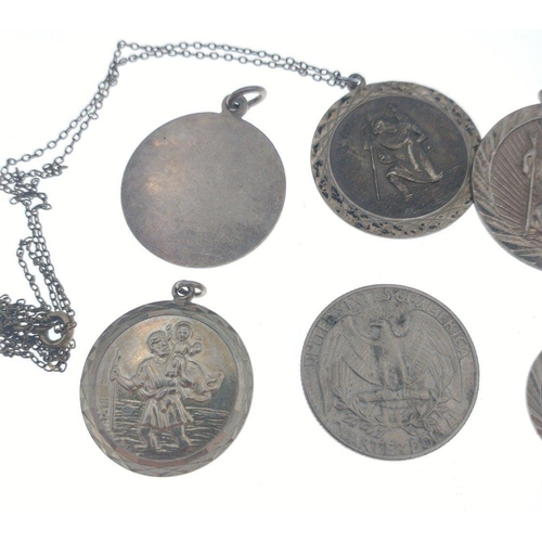 36 - Four silver stamped St Christopher pendants (1.5 - 3cm dia) also with a silver stamped disc, a 1973 ... 