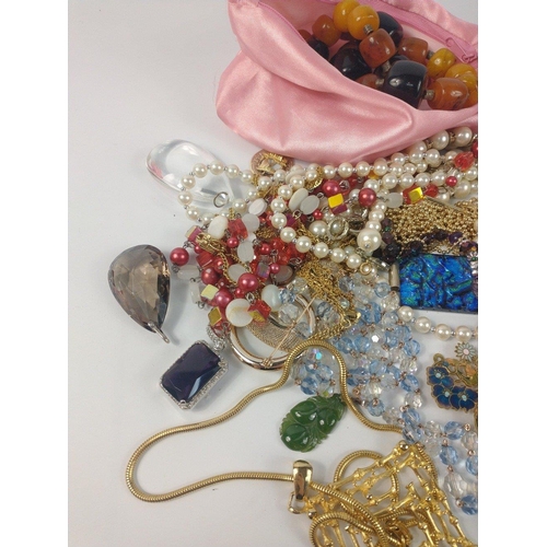 54 - A bag full of costume jewellery to include faux pearls#57