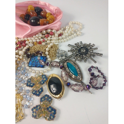 54 - A bag full of costume jewellery to include faux pearls#57