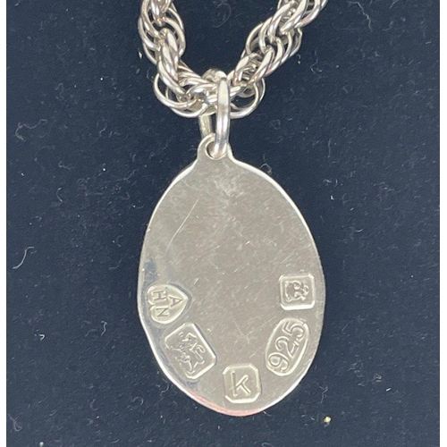 430 - A silver hallmarked pendant (2cm), London 2009, on a silver chain 42cm long, weight 14g plus a white... 