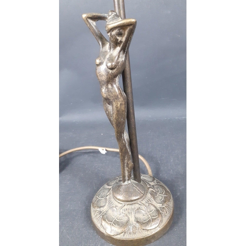 624 - A brass table lamp with a naked lady (21cm tall approx) supporting stem and a HERON GLASS iridescent... 