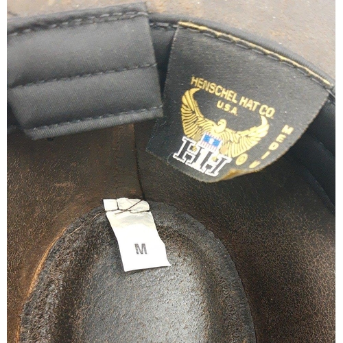 799 - A brown leather cowboy hat from the HENSCHEL HAT CO of the USA , size medium (7-7 1/8) and a brown w... 