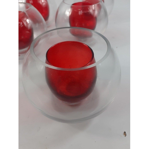 814 - 8 Tealight candle holders in red coloured glass set in clear glass globes , the globes measure 12cm ... 