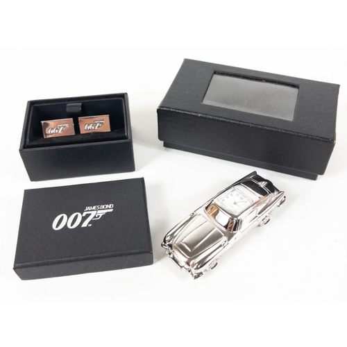 142 - ASTON MARTIN a miniature metallic silver model car (8cm long) with embedded quartz clock plus a set ... 