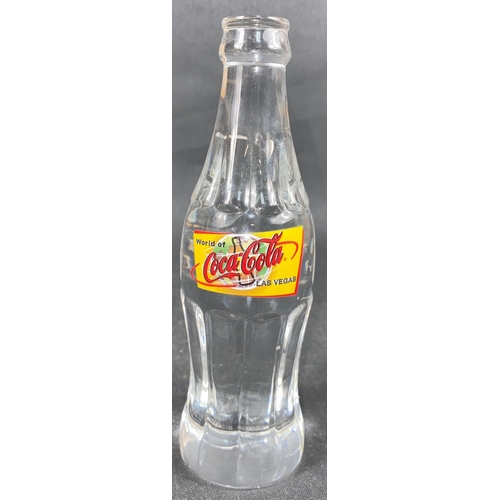 263 - A solid glass COCA -COLA bottle with label 'World of Las Vegas', stands 19.5cm tall#263