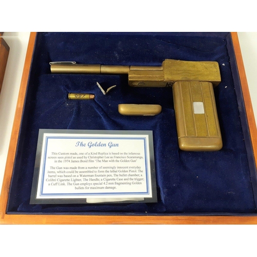 94 - JAMES BOND 007.  THE MAN WITH THE GOLDEN GUN.  Two boxed Golden Guns in wooden presentation cases.  ... 