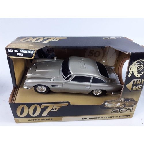 99 - JAMES BOND - three Toy State 007 motorized lights and sounds model cars to include a black ASTON MAR... 