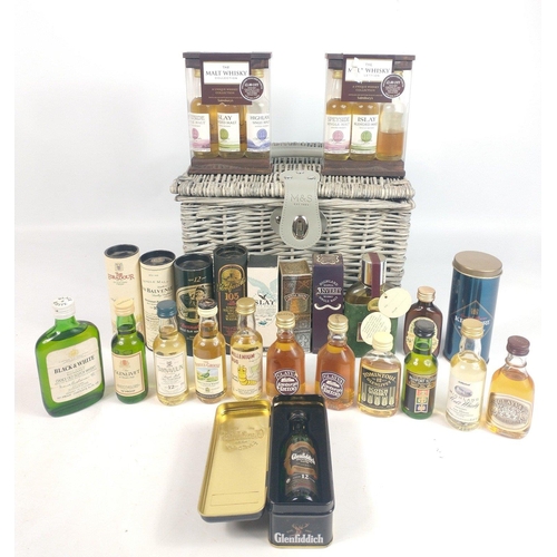 668 - A handy-sized M&S wicker basket (30x26x20cm) with a full complement of 50ml whisky miniatures to... 