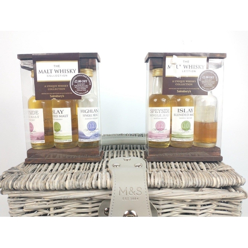 668 - A handy-sized M&S wicker basket (30x26x20cm) with a full complement of 50ml whisky miniatures to... 