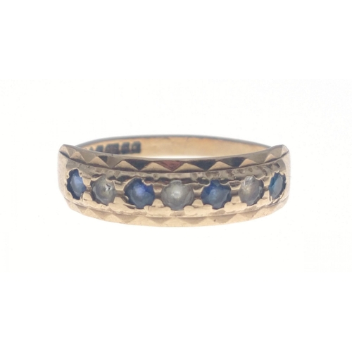 1 - A 375 stamped yellow gold half eternity style ring with four blue sapphires and three clear stones s... 