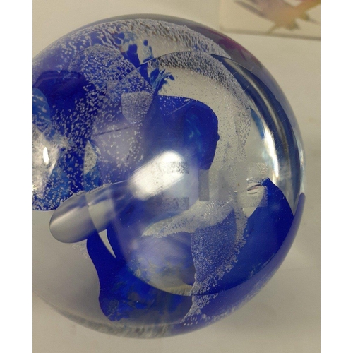 103 - A CAITHNESS GLASS paperweight with blue and white wave designs marked to the base CG#114