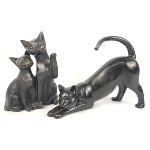 152 - Two smooth cat figurines the first of a black cat stretching 24cm long, the second a pair of black c... 