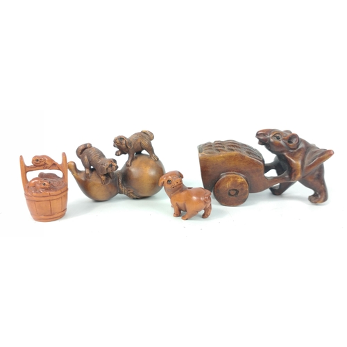 158 - A small collection of carved wooden netsuke to include a mouse pushing a wheelbarrow, a small dog, 2... 