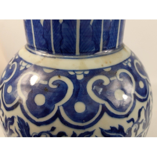 175 - A vintage blue and white Chinese vase 40cm high with a scrolling floral pattern, no marks to the bas... 