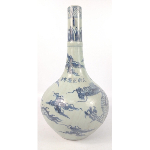 177 - An antique blue glaze Chinese tall-necked vase with a decoration of chasing dragons, and a hoop for ... 