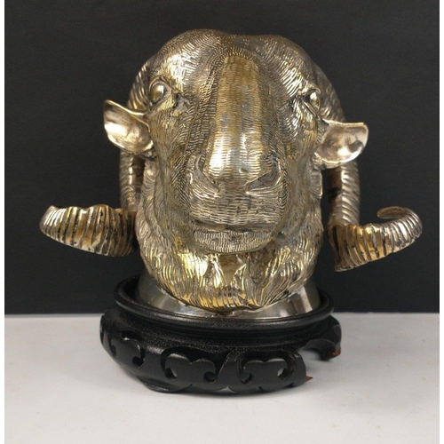 180 - A silvered bronze ram's head with wooden plinth, can be wall-mounted, stands approx 15cm tall, 20cm ... 