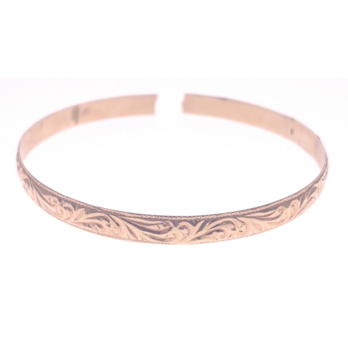 18E - 18ct jeweller tested with an indistinct Spanish hallmark yellow gold bangle which has been broken th... 