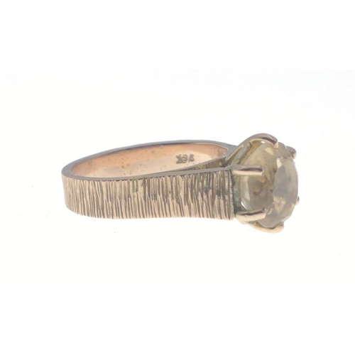 2 - A 9ct stamped yellow gold ring in a bark effect finish size M with a SUBSTANTIAL white stone - gross... 