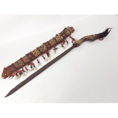 234 - Highly decorated Indonesian / Asian Kris style sword in elaborate sheath decorated with animal teeth... 