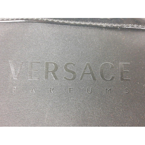 248 - A black fabric shoulder bag with patent shoulder and strap labelled Versace Parfums, 1 zipped compar... 