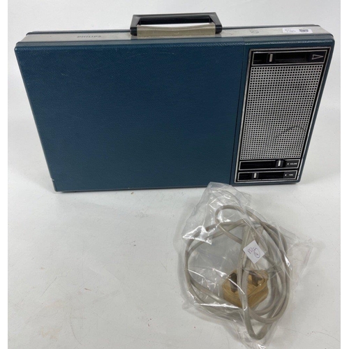 254 - A vintage PHILIPS briefcase-style portable record player with a dark blue cover, still has adapter f... 