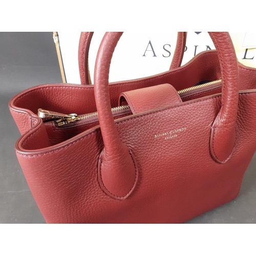 328 - A bordeaux pebble tote mini handbag stamped ASPINAL of LONDON with 2 interior compartments plus 2 zi... 