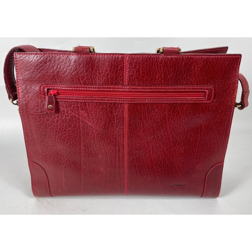 329 - A quality LAND burgundy pebble tote bag with leather exterior, fabric lining, one external zipped co... 