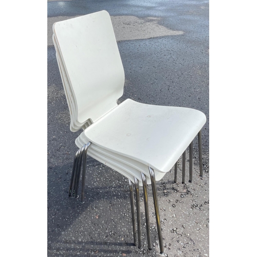 341 - A set of four white modern dining chairs of wooden construction and tubular legs and frame - ideal f... 