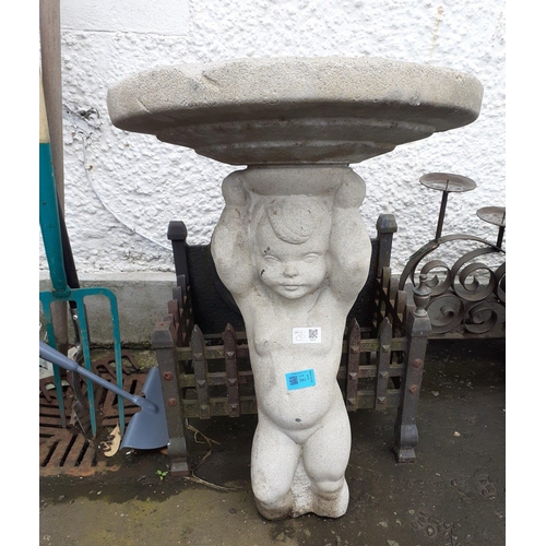 393 - A very old two piece bird bath consisting of a small boy holding up the bath which has been repaired... 